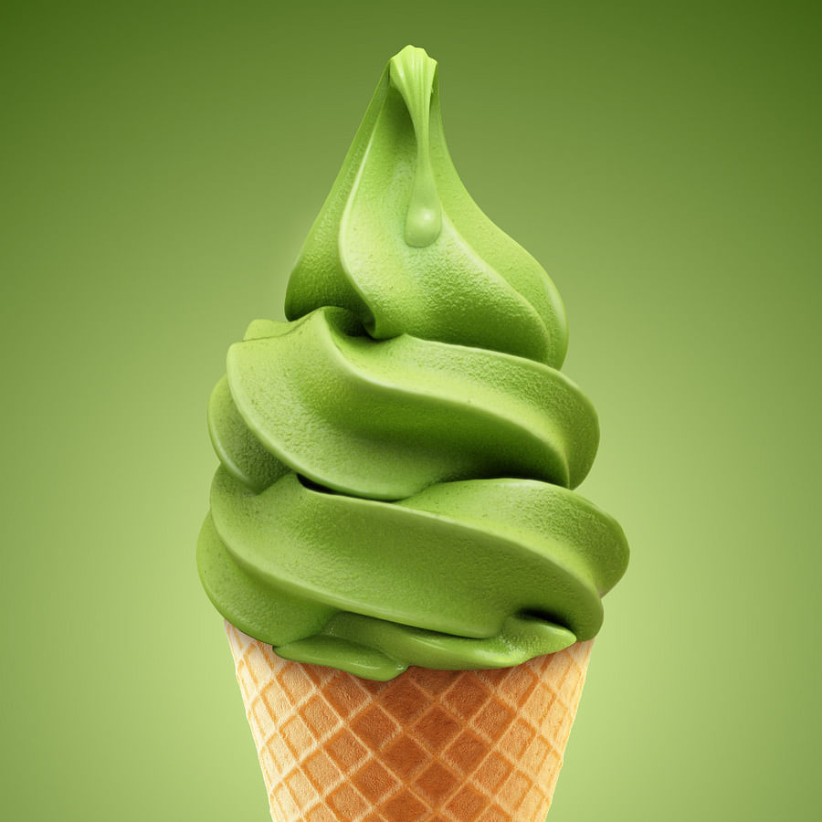 Scoop of matcha ice cream in a cone on a sunny day
